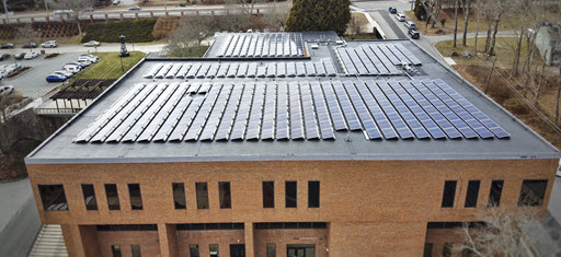 Daytime aerial view of solar panels on the roof of a Coast Guard Academy building