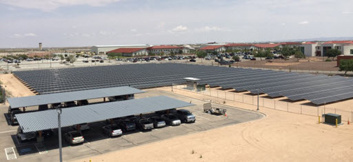 Daytime aerial view of solar carports and a ground-mount solar farm at the DEA El Paso Intelligence Center
